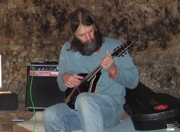 Alan Robinson playing guitar in a sandstone cave at Loggerheads public house Nottingham